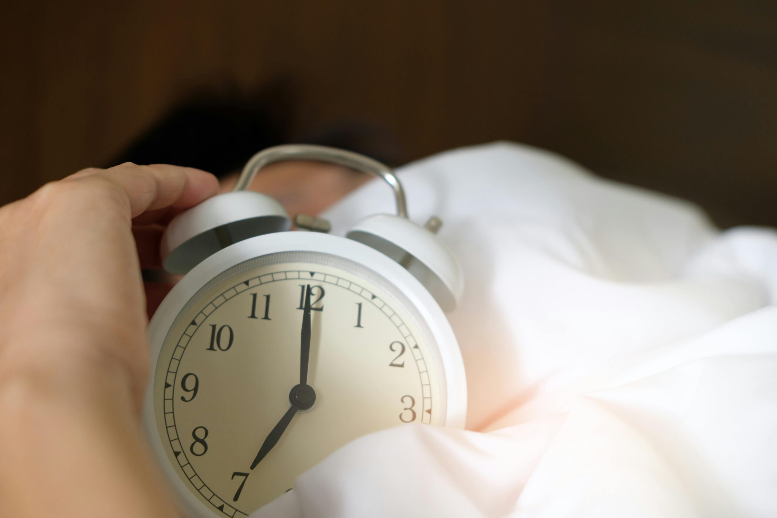 Alarm clock in a white duvet